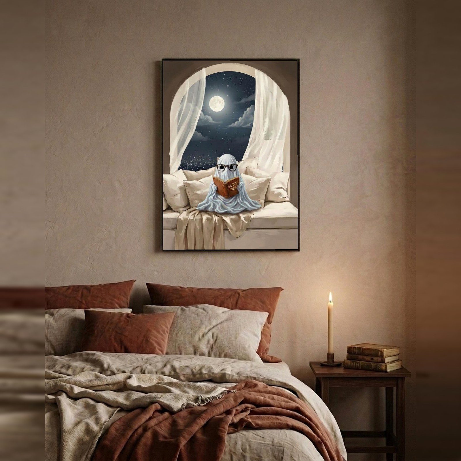 Moonlit Ghost Wall Art, A small ghost in round glasses, propped up on pillows with a book, the moon full in the window and the city gone quiet below.